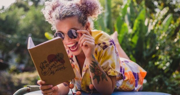 Girl outdoors reading a book