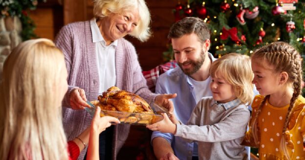 Family being served turkey at Christmas dinner table