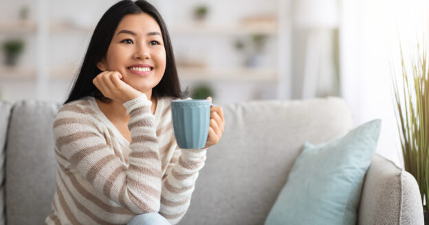 Positive woman drinking coffee